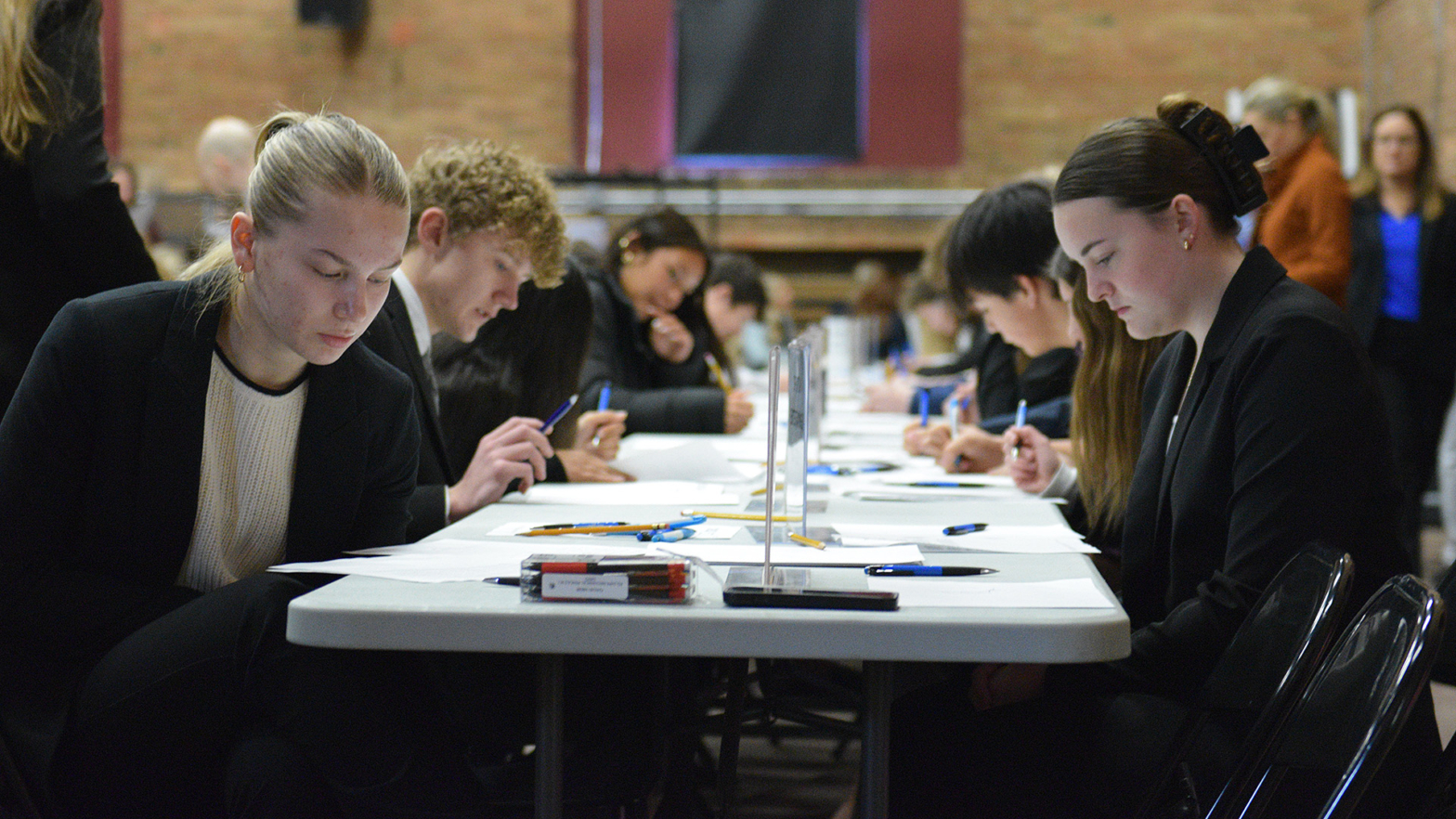 Students sit at a table and take tests during the Emerging Leaders Competition at VCSU