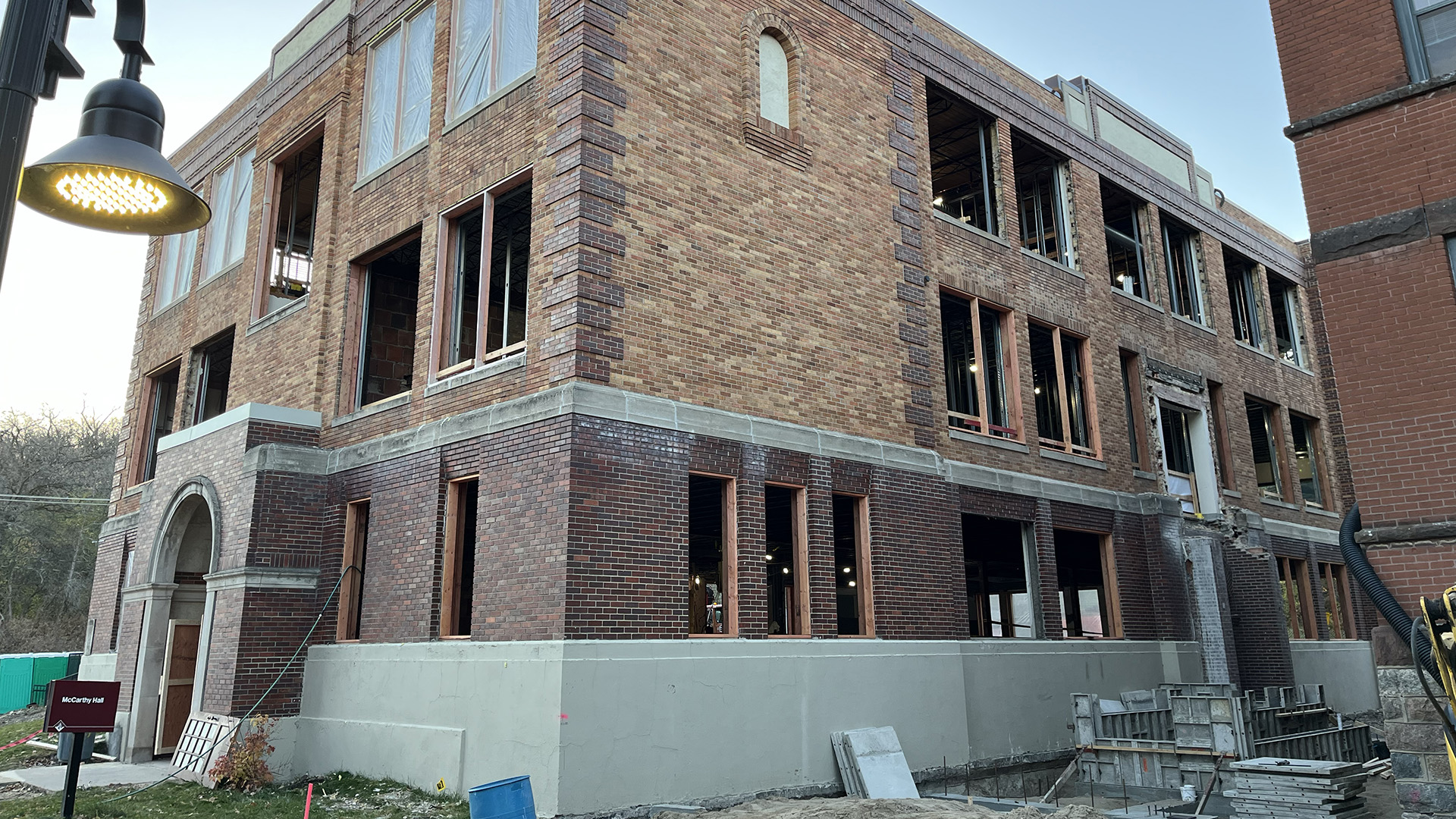 McCarthy Hall's windows are removed and concrete work is being done outside the building.