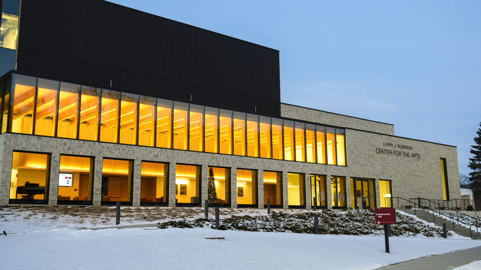 VCSU's Center for the Arts shines bright during the early evening with white snow on the ground.