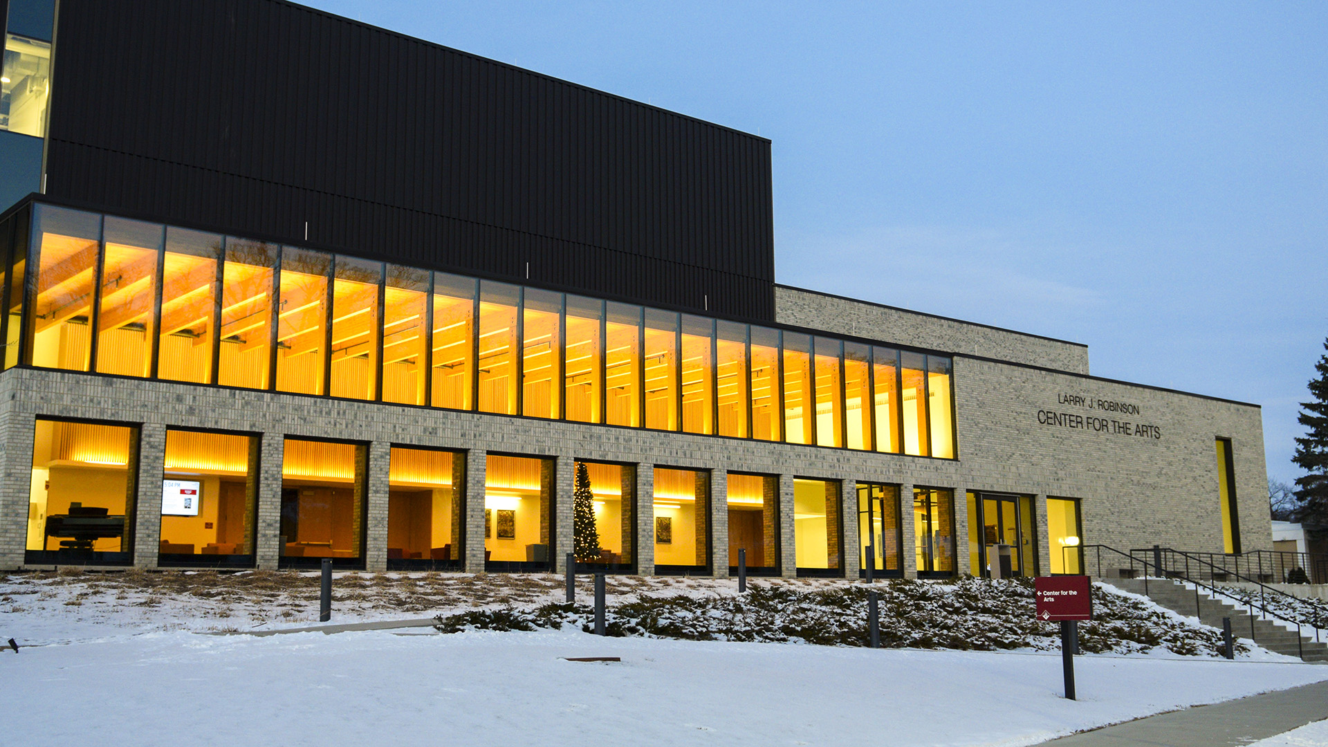 VCSU's Center for the Arts shines bright during the early evening with white snow on the ground.