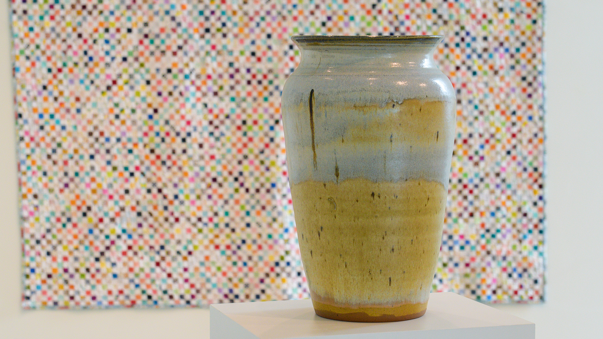 A pottery piece and a quilting piece are shown from the 2024 Faculty and Staff Exhibit