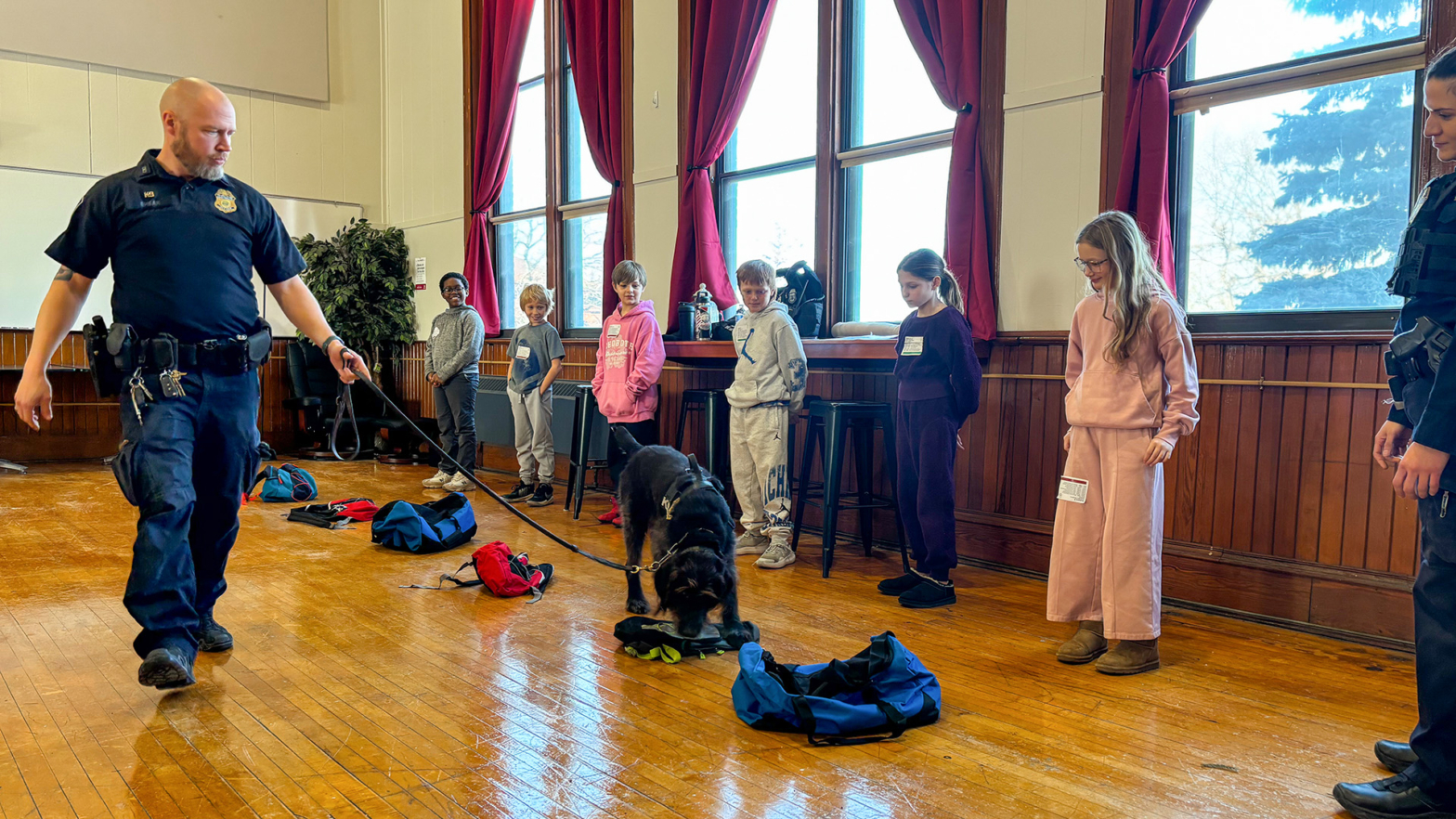 Students watch "Rex", a canine with the Border Patrol, do a demonstration.