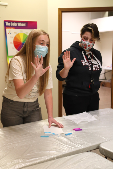 Art students demonstrating using hands