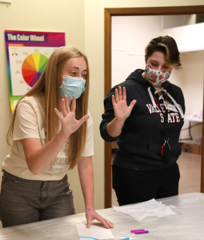 Art students demonstrating using hands