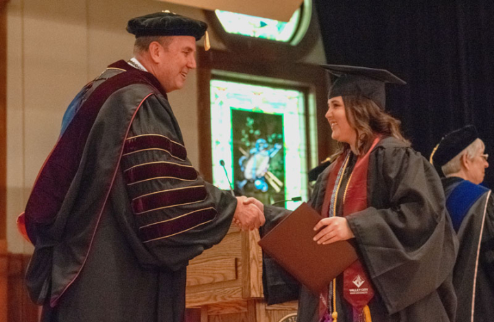 VCSU President Alan LaFave congratulates a graduate during winter Commencement in December of 2021