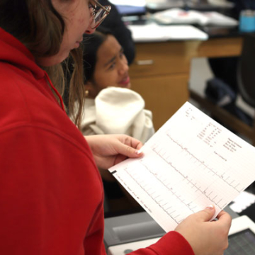 A student reads an EKG print out in the VCSU science lab