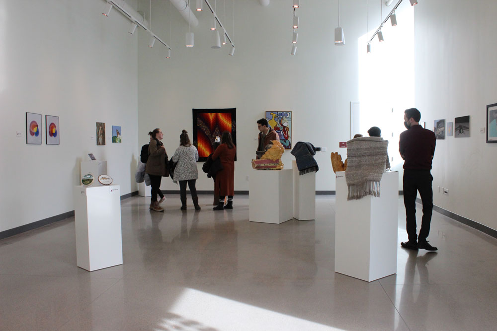 Visitors view art in the new art gallery.