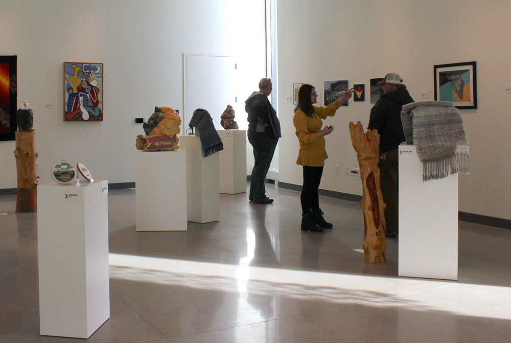 Individuals look at art in the new Center for the Arts 