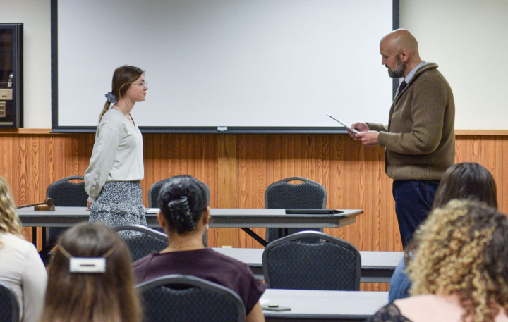 A student being inducted into Psi Chi by Professor Anthony Dutton.