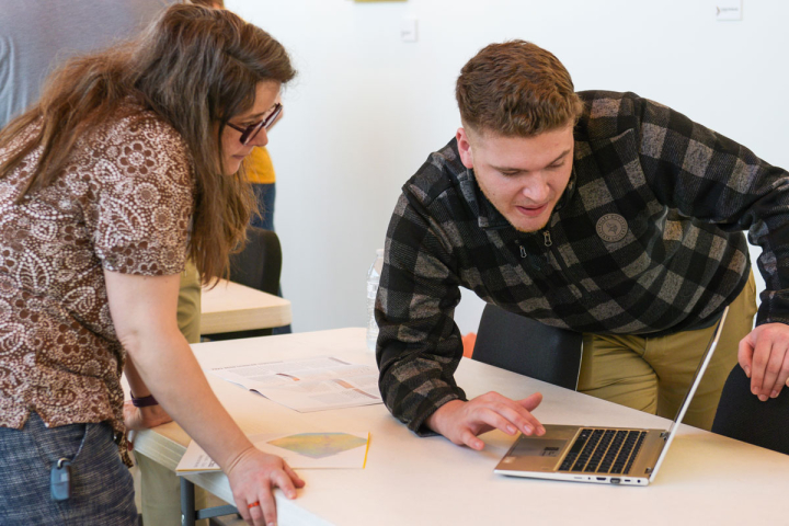 A VCSU computer programming student presents his project to a faculty member