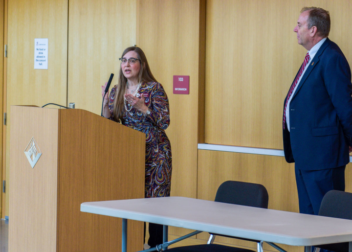 Professor Emily Wicktor speaking at the podium