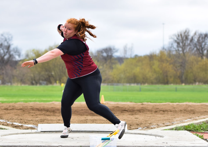 Hannah Gordon prepares to throw a shotput at a track event. 