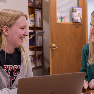 career services director working with student worker