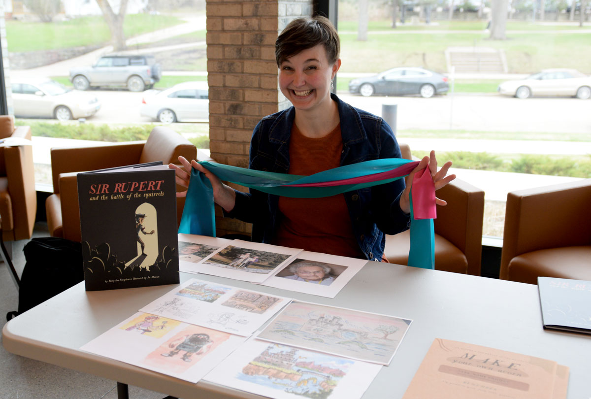 A student with their research project during the scholar symposium