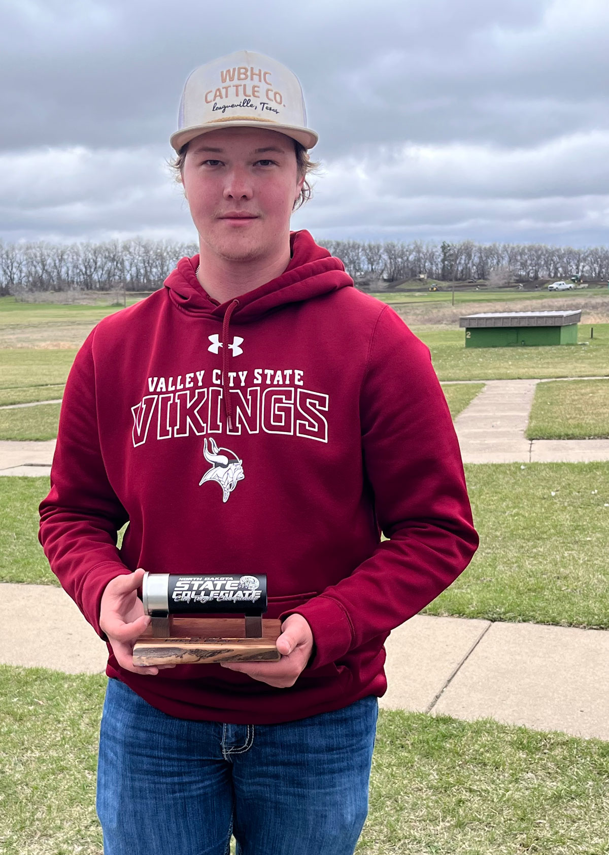 Kaden Schafer stands with his award from the Trap Shooting competition