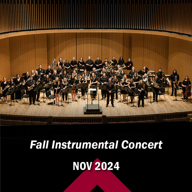 full band posing with instruments in performance hall