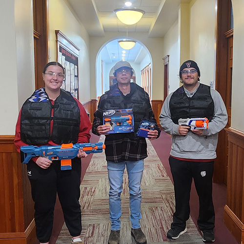 3 individuals holding NERF guns