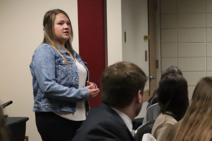 Amber Kologi speaking at banquet