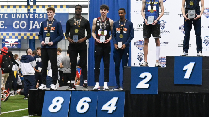 Peraza on podium holding award