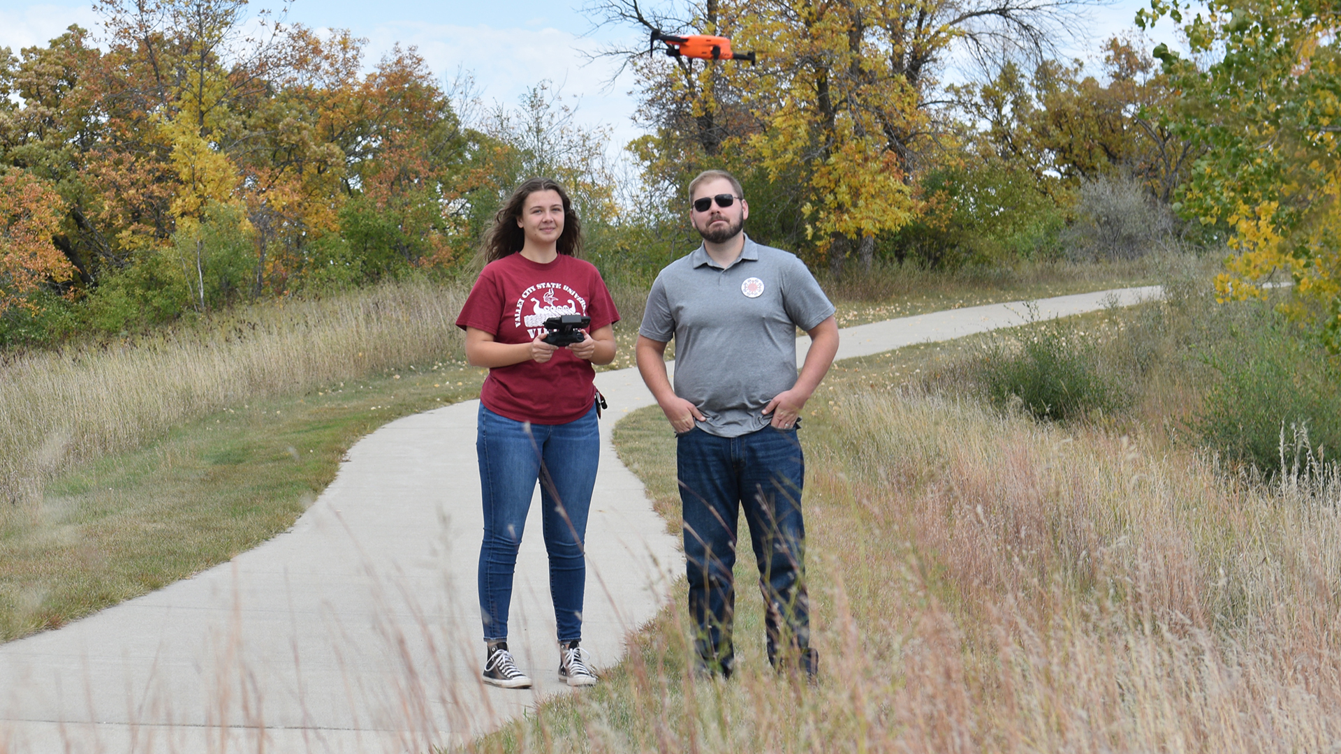 VCSU professor Jacob Clauson and a student fly an unmanned aerial vehicle at Medicine Wheel Park.