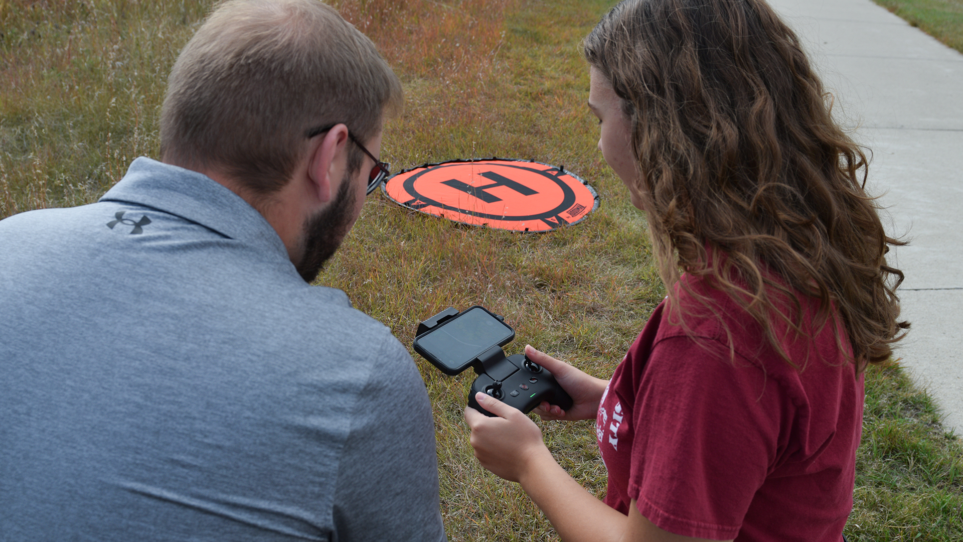 VCSU professor Jacob Clauson and a student fly an unmanned aerial vehicle at Medicine Wheel Park.