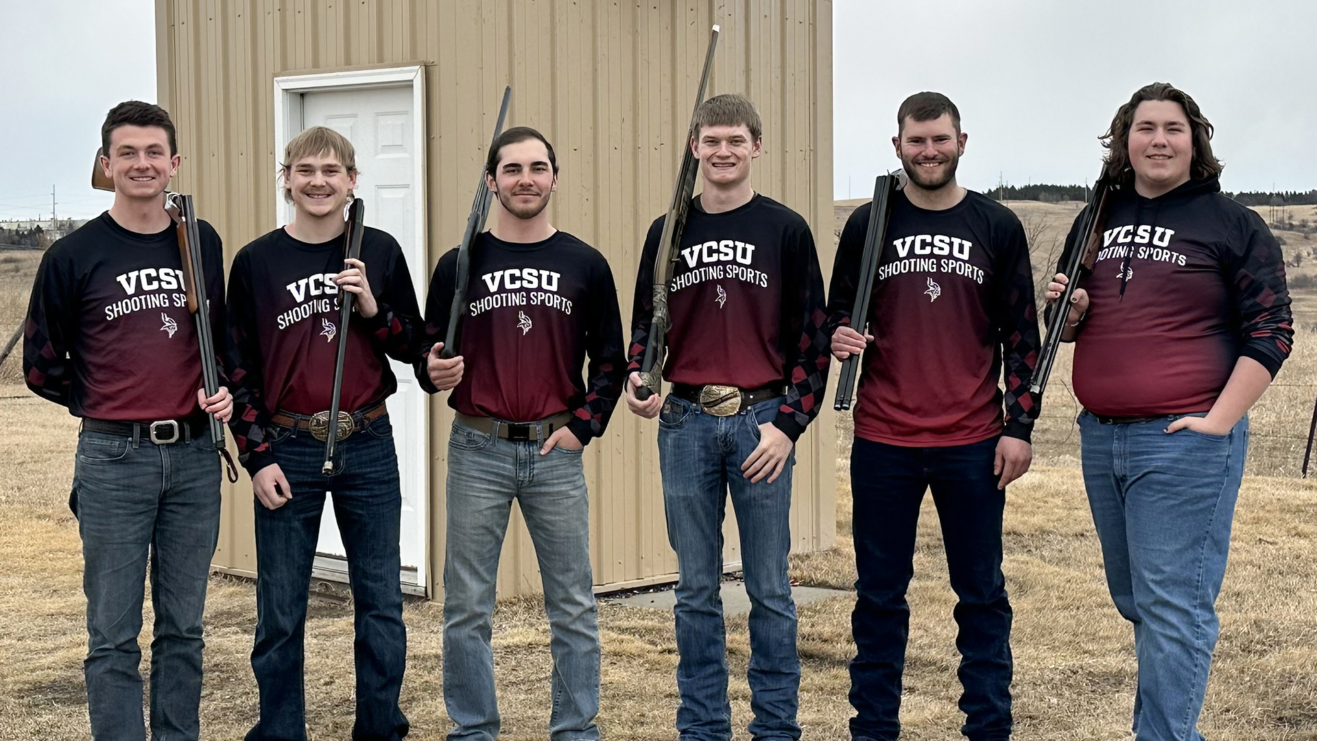 The 6 VCSU skeet team members hold shotguns for a picture while wearing VCSU Shooting Sports jerseys