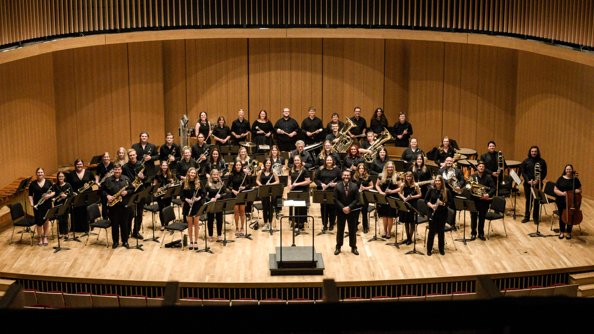 The VCSU Concert Band standing on stage during a rehearsal.
