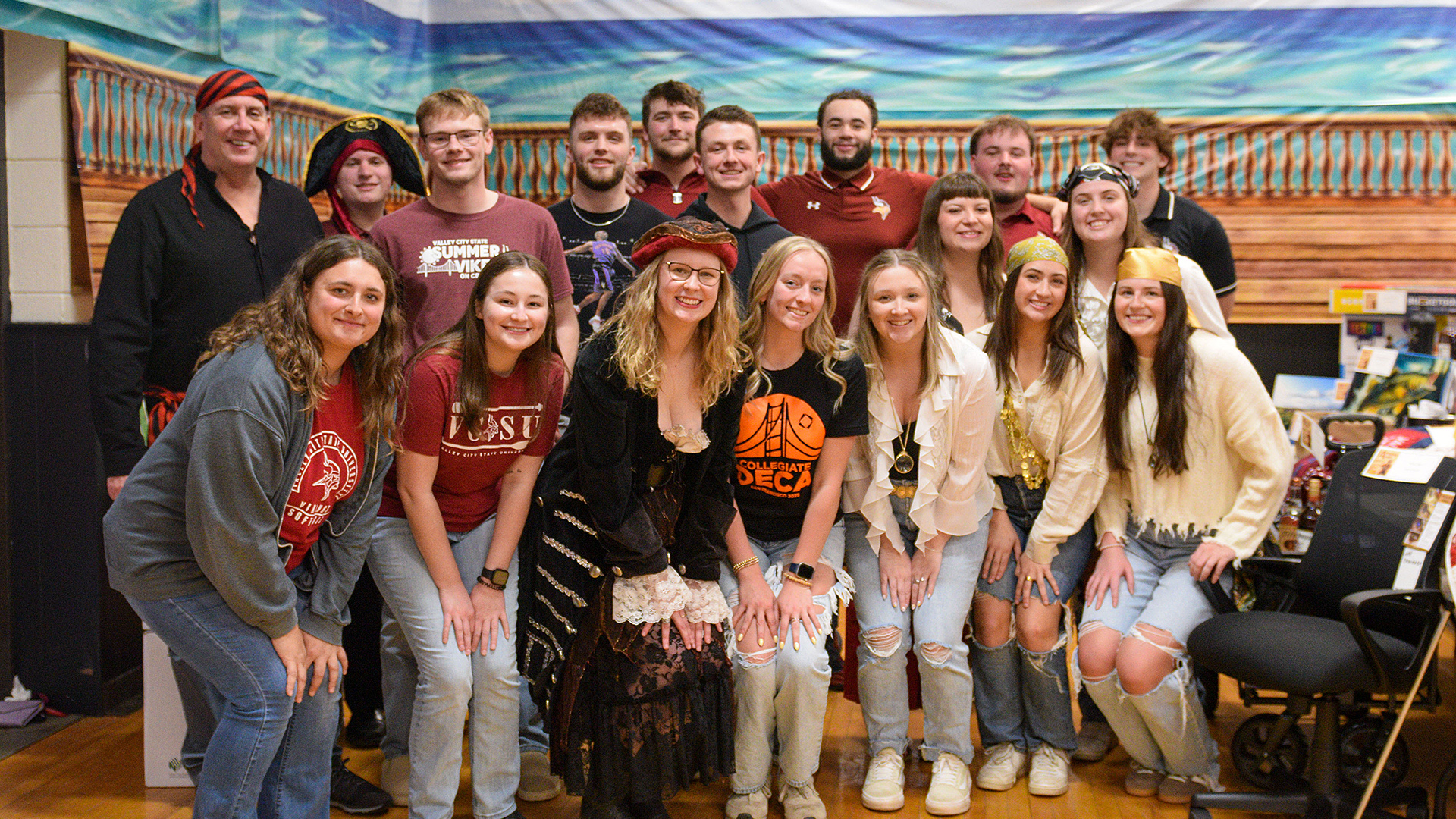 VCSU president Alan LaFave is pictured with numerous students who volunteered at the scholarship auction.