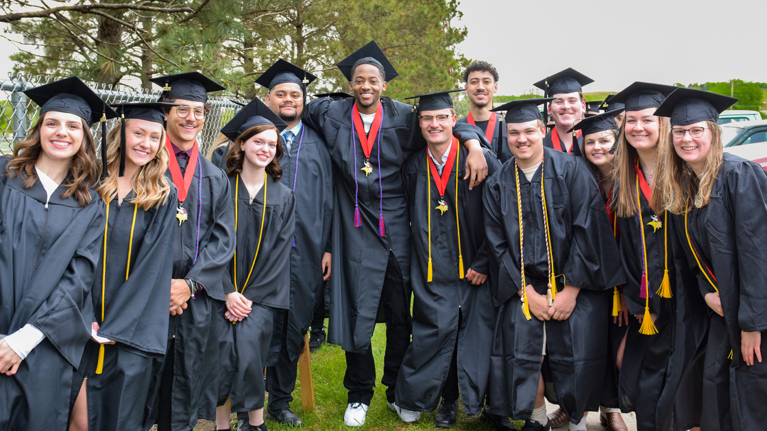 VCSU graduates smile in a group prior to the ceremony.