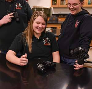 VCSU students are pictures using older binoculars, which will be replaced soon