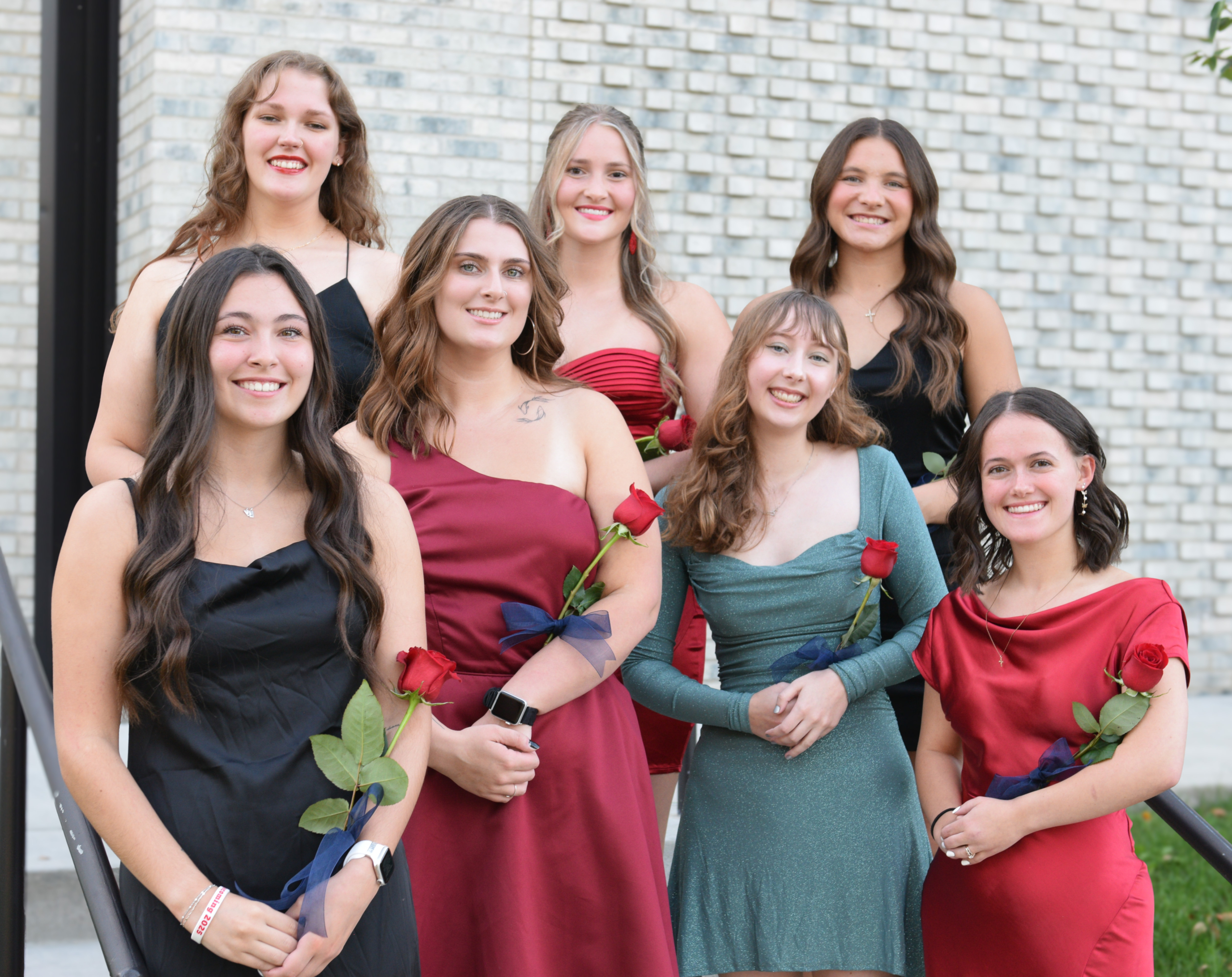 Alliana Freund smiling at the camera with six other VCSU female students