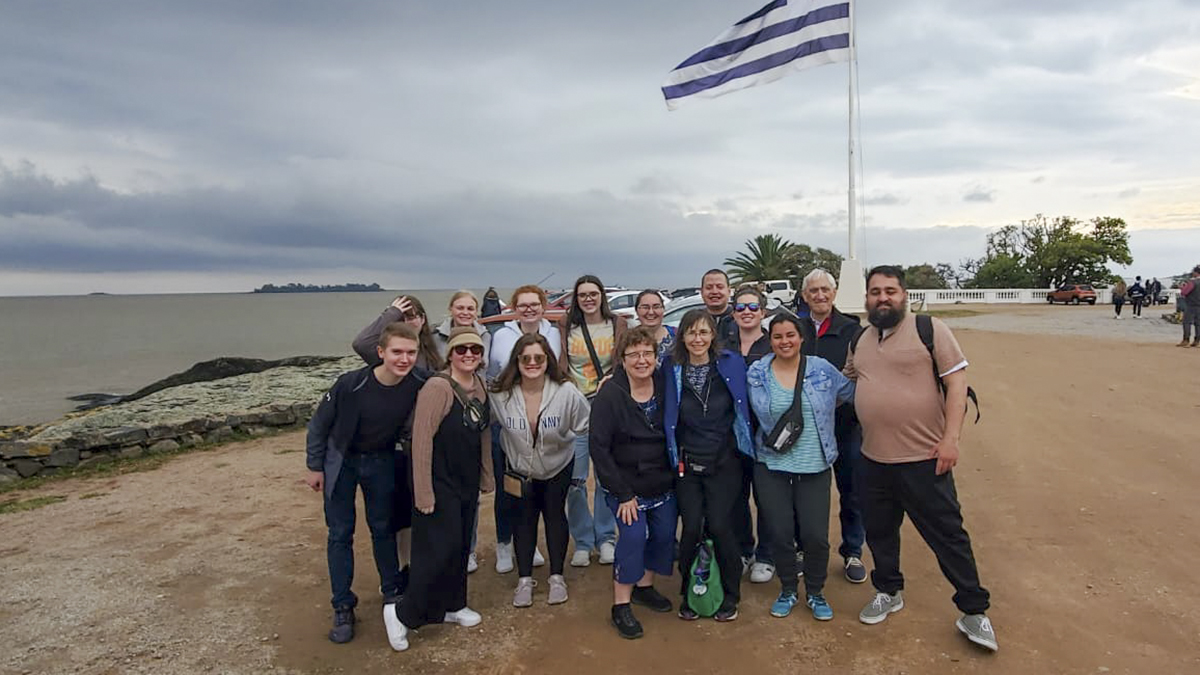 group posing for photo on beach