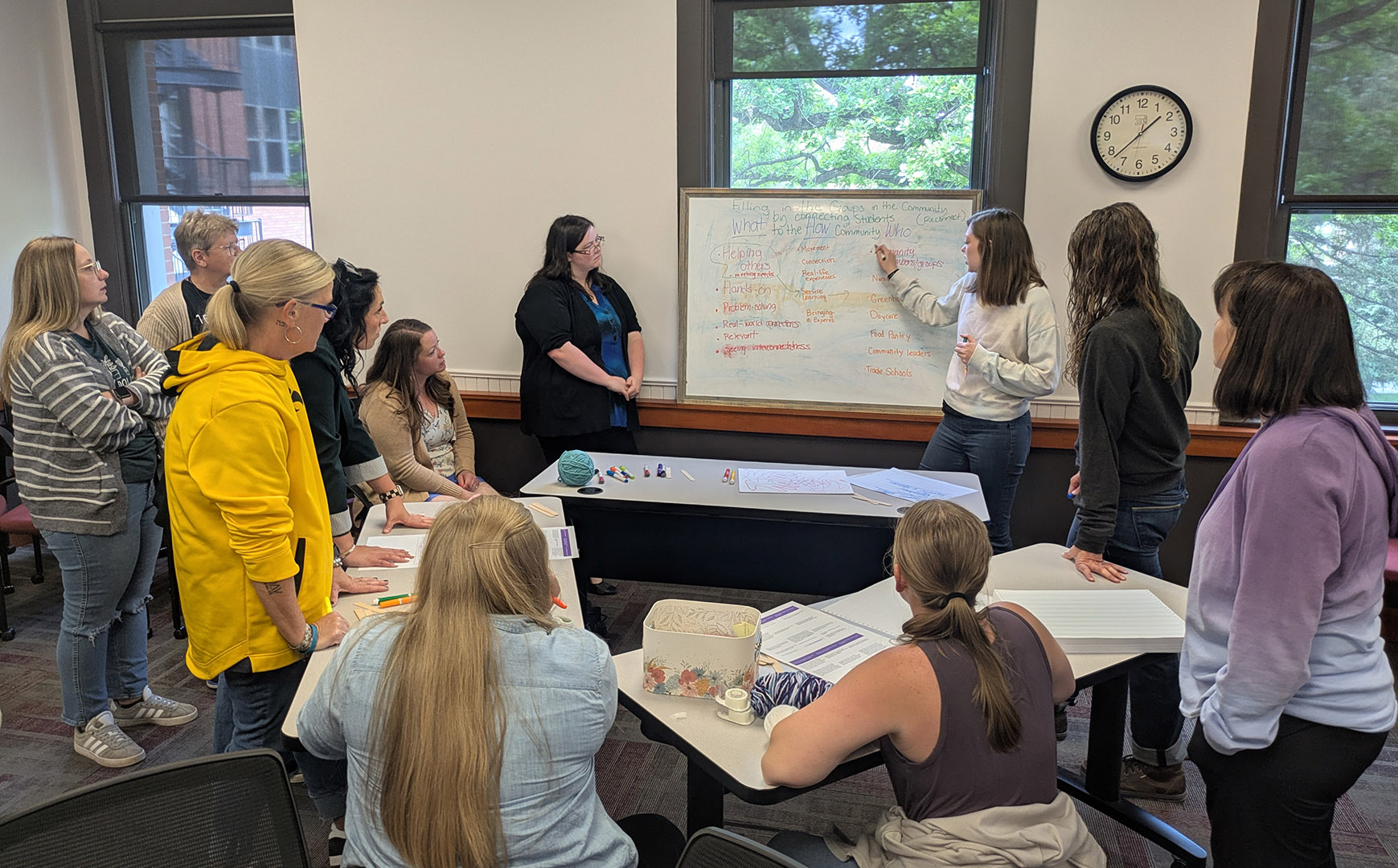Teachers in the incubator program do an activity during the opening session.