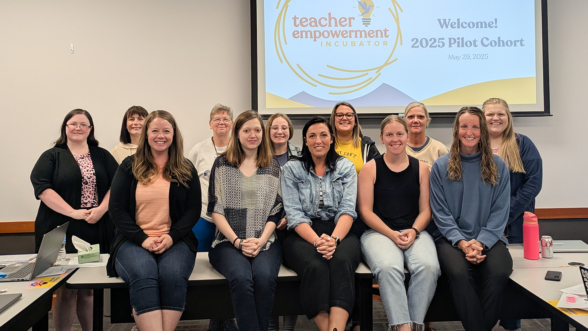 12 teachers participating in the incubator pose for a group picture