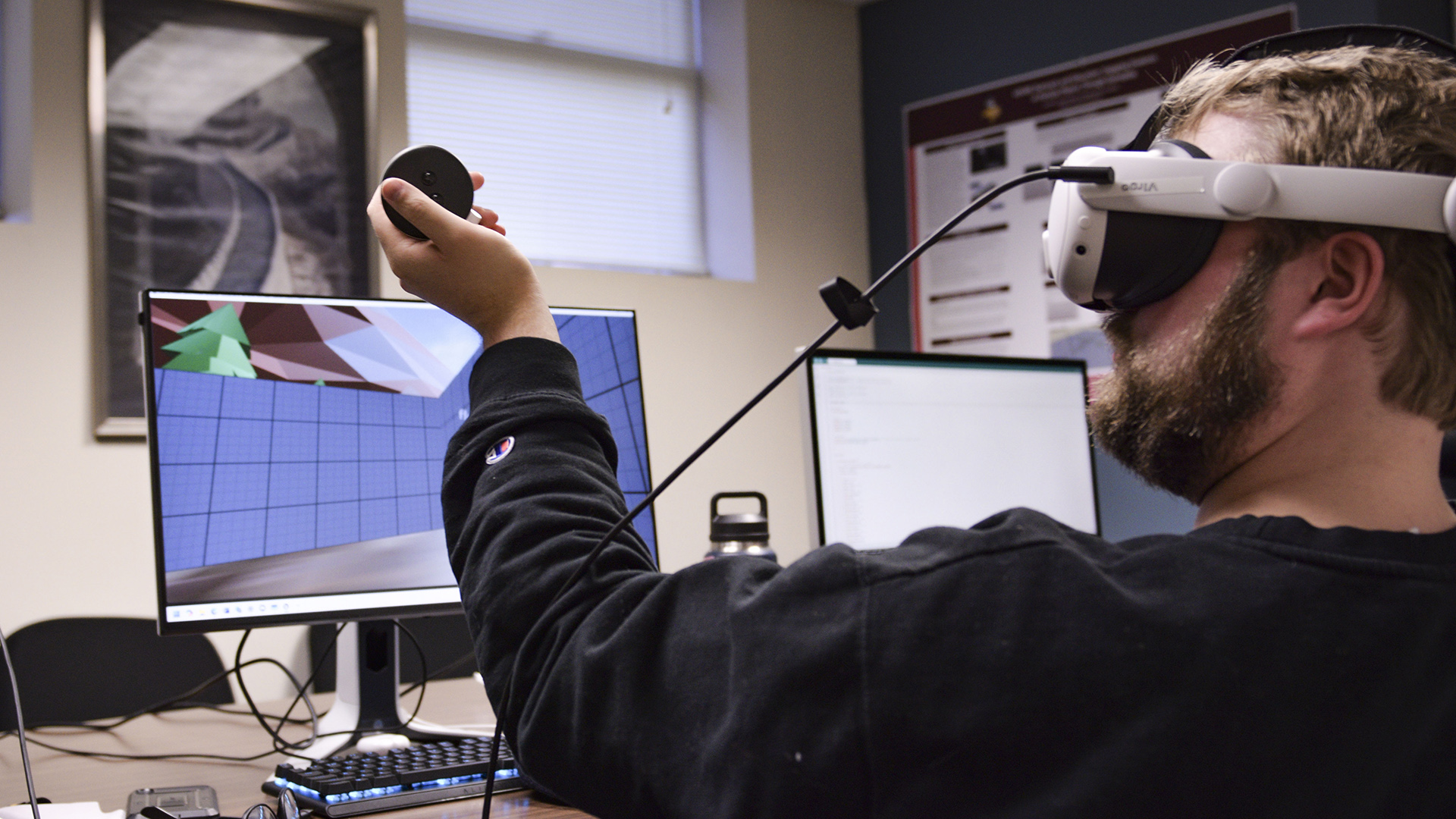 A VCSU student uses virtual reality equipment to navigate a video game he created.
