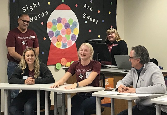 Governor Burgum visits with education students Kadie Anderson and Clarissa Olson as faculty members Tim Michaelson and Amber Aberle look on.