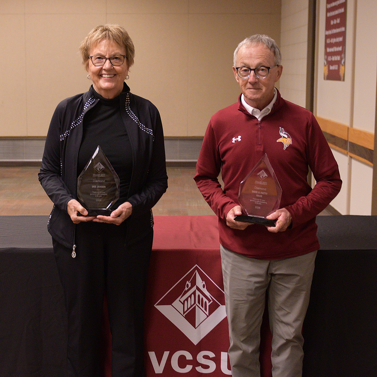 Dee Jensen and Dave Bass hold crystal donor awards