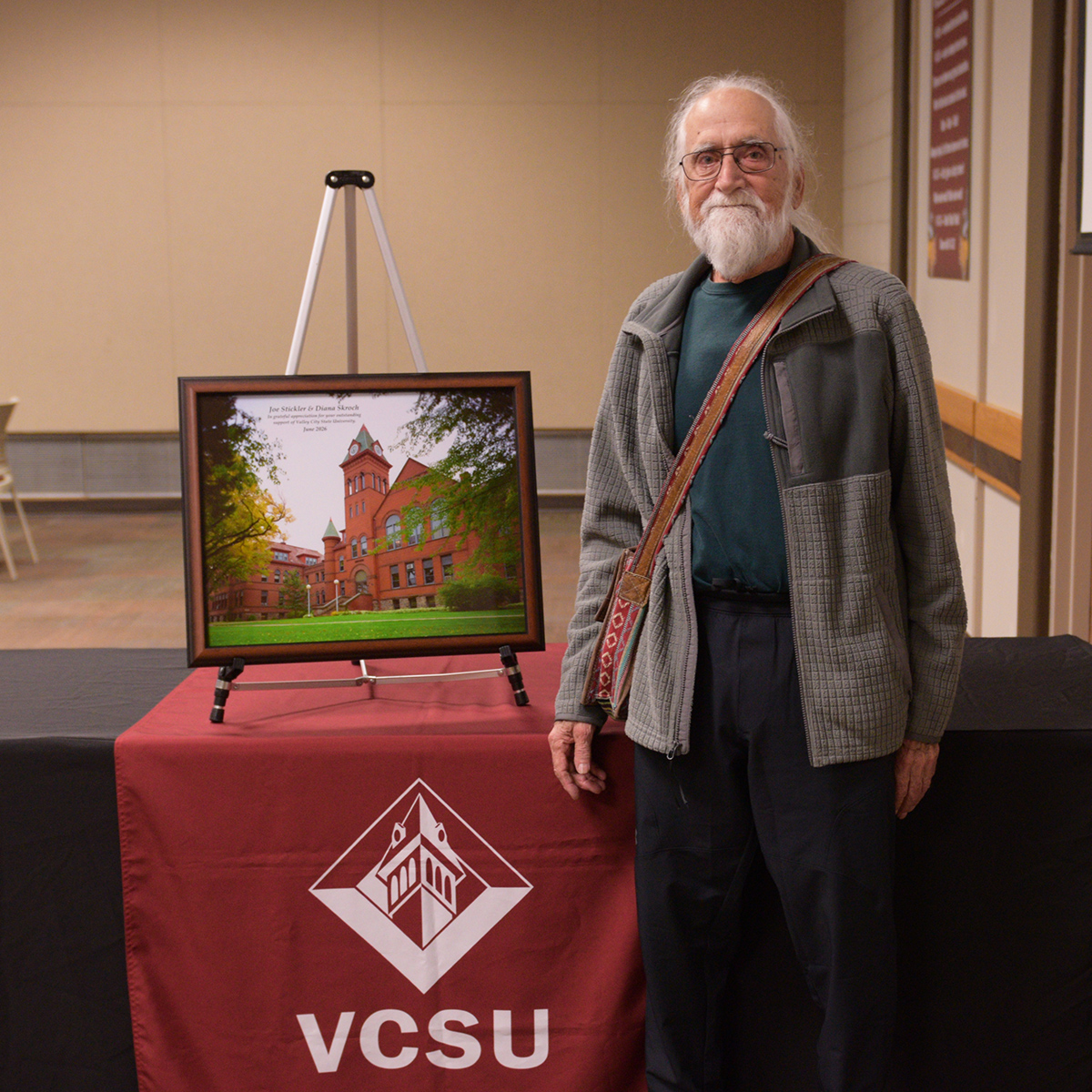 Joe Stickler stands with a picture he received as a thank you.