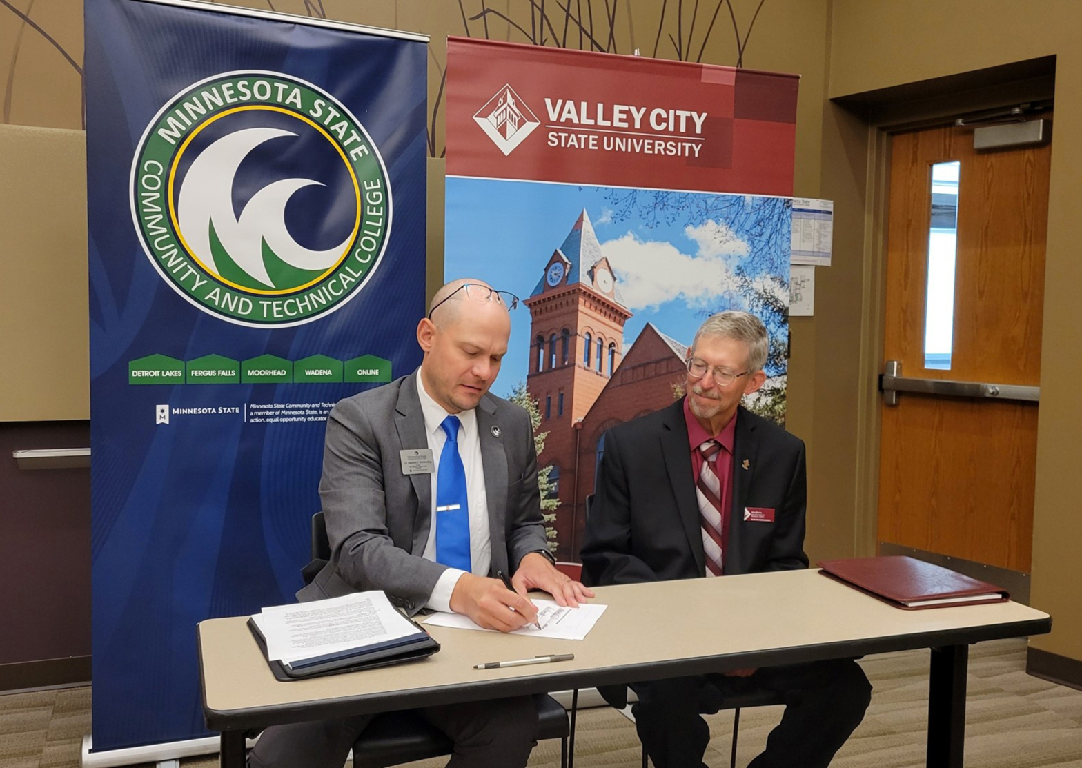 Dr. Matt Borcherding, Provost/Vice President for Academic Affairs at M State (left), and Larry Brooks, Vice President for Academic Affairs at VCSU are pictured at the signing ceremony