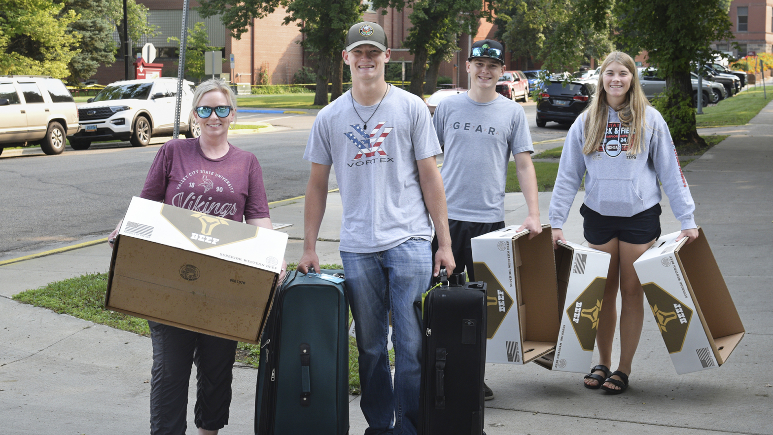 A VCSU student and his family carry boxes of items during 2024 Move In Day.