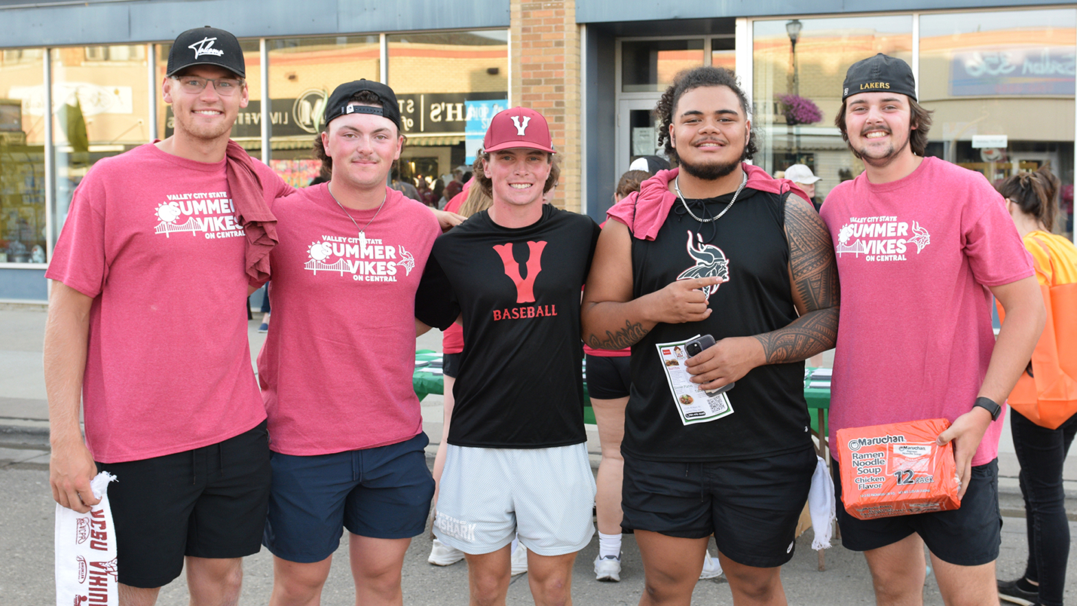 5 VCSU students smile at the camera in downtown Valley City