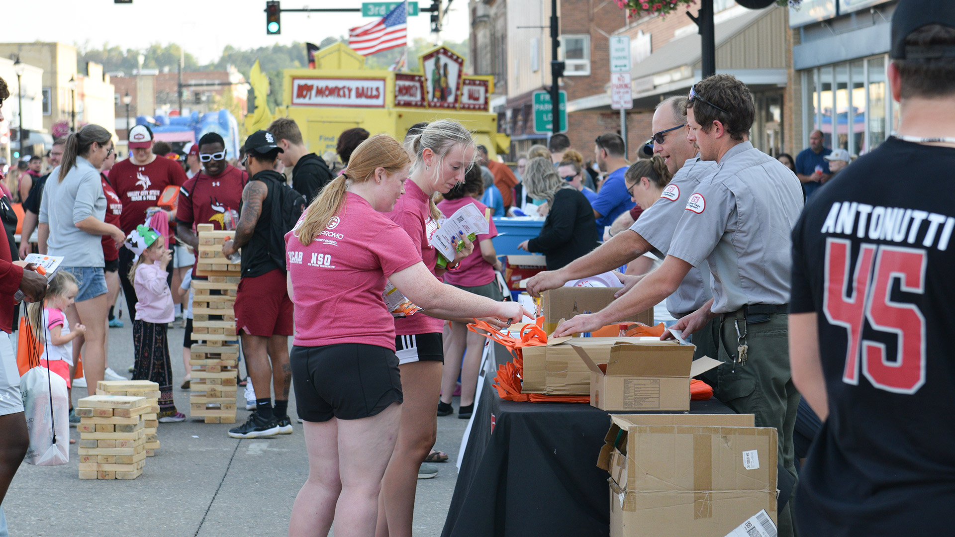 VCSU students visit various business booths set up on Central Avenue in Valley City during 2024 Summer Vikes on Central.