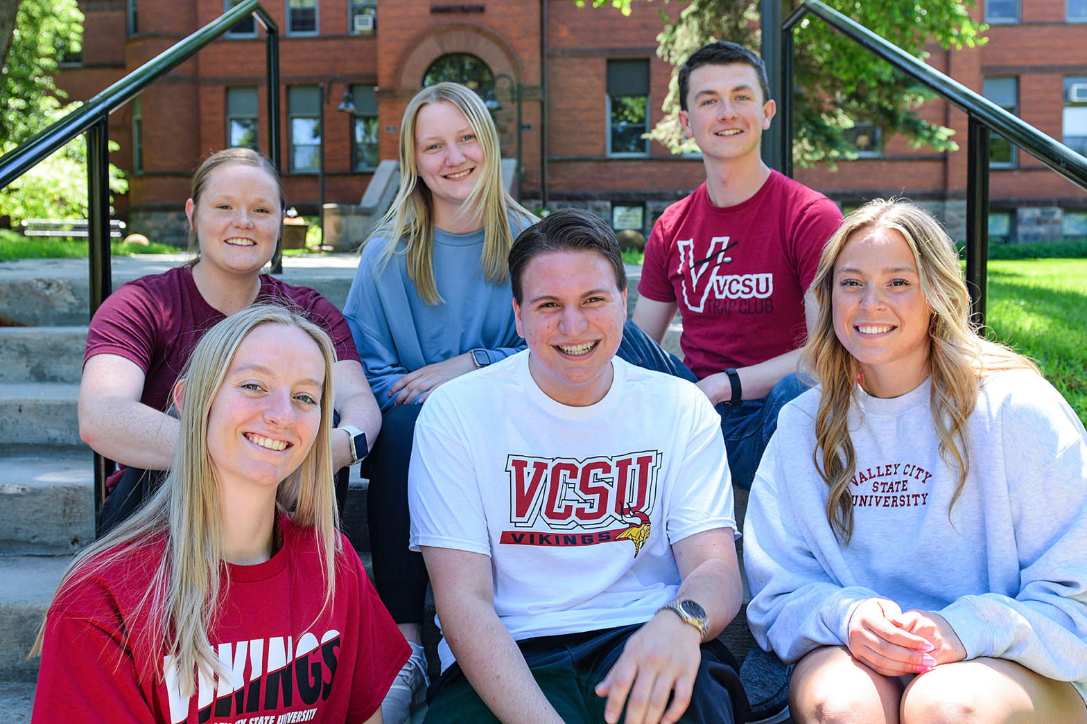 VCSU students sit on the steps in front of McFarland Hall.