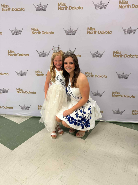 A young girl and Abby Hill smiling at the camera