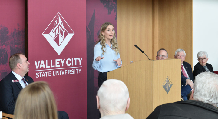 Angeline Gannon, former student body president, speaks at the ribbon cutting event for the center fo rthe arts.