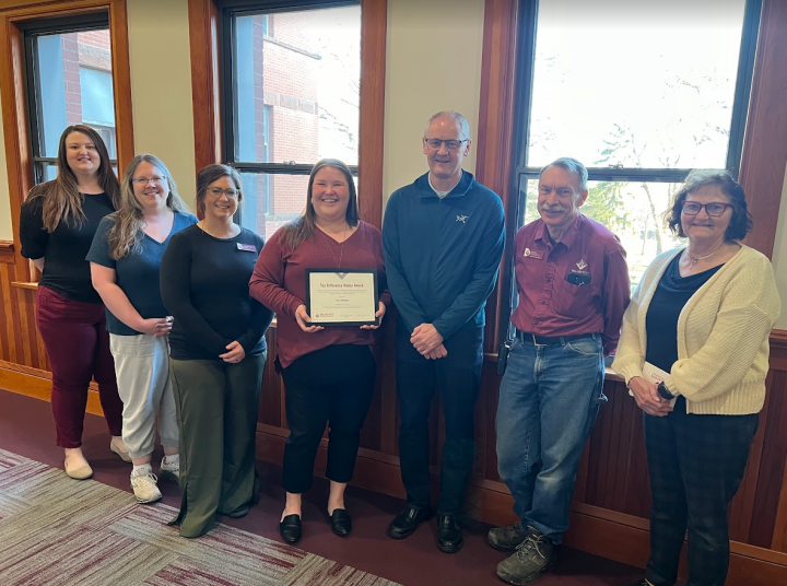 Erin receiving award from group