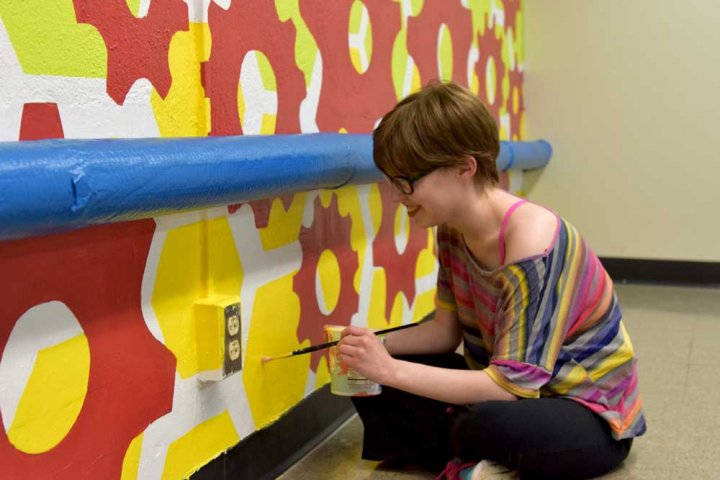 art student working an library mural