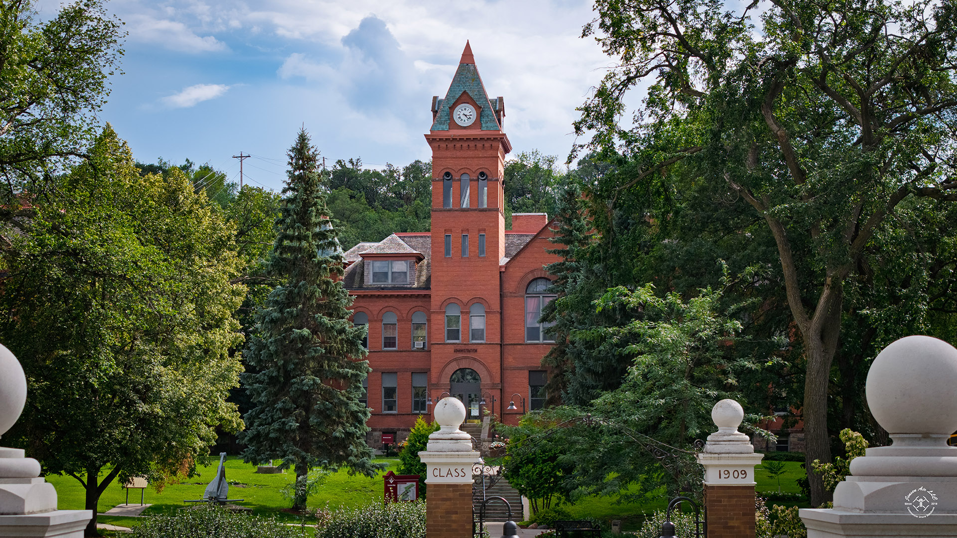 VCSU's McFarland Hall is shown framed by green trees in the summertime.