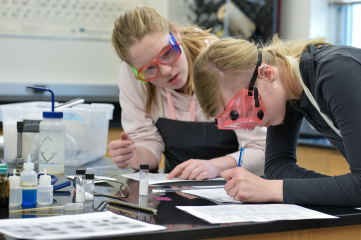 female students conducting experiment