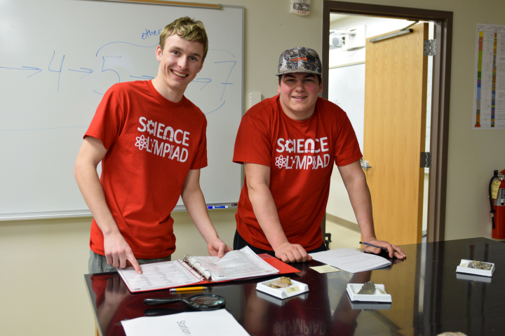 male students studying rocks